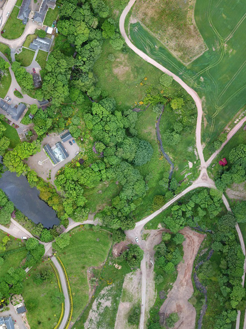 Drone Survey photography used on a small green area with houses and trees