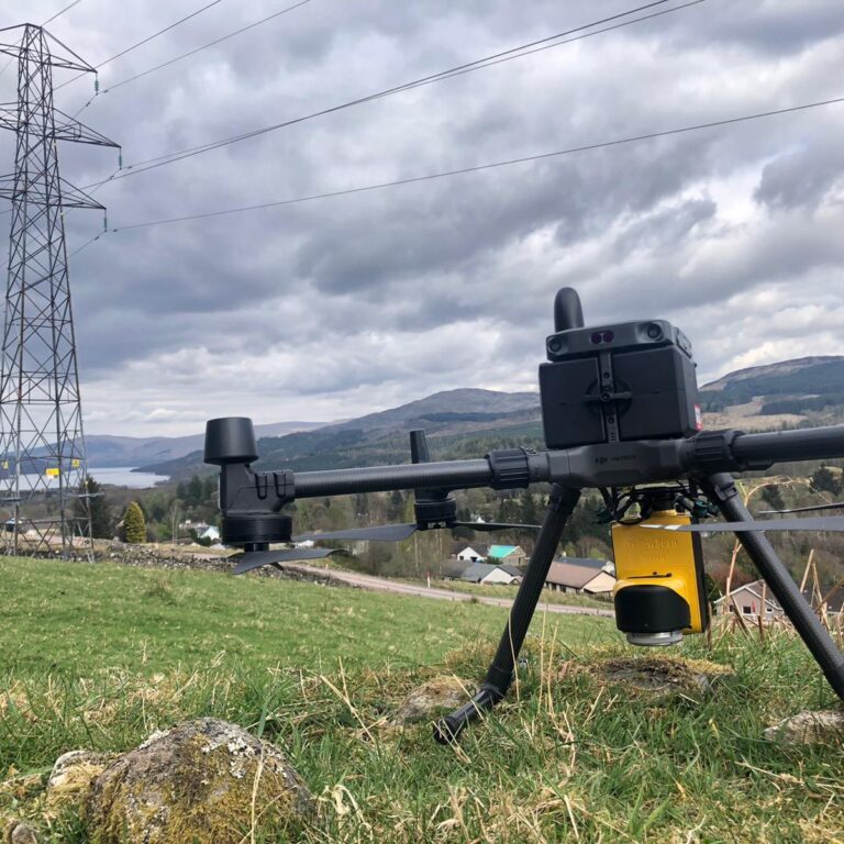a large drone with LiDAR put on a grassy land on a cloudy day